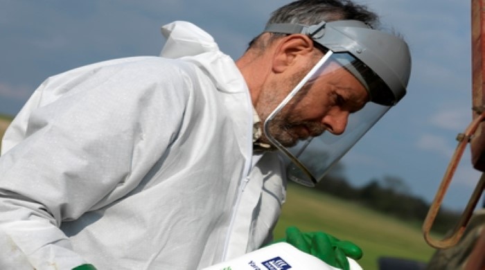 Farmer with a tub of tankmix 